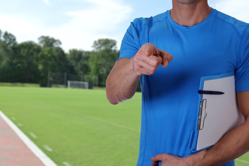 Football, soccer trainer with workout plan close up on football
